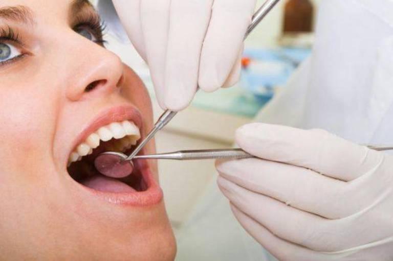 Стоматолог осматривает рот